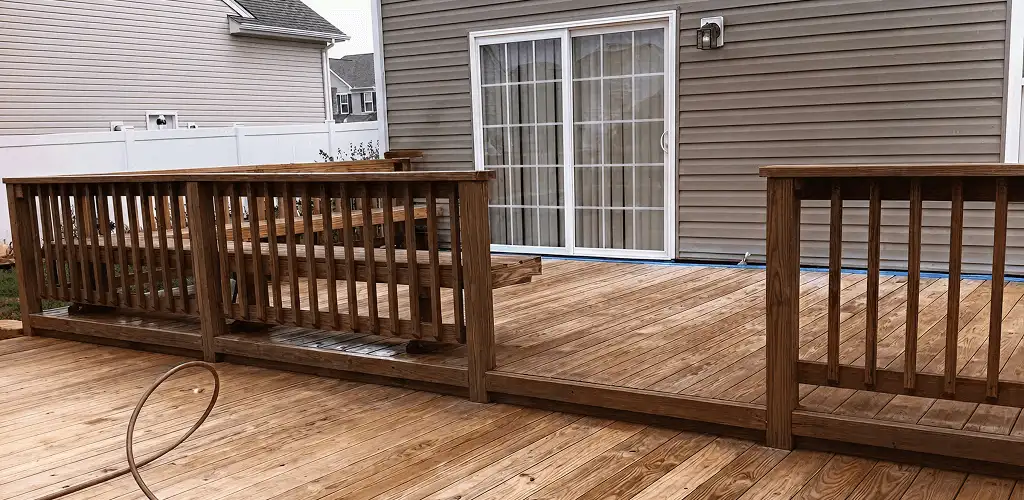 Deck sealing service protecting a backyard wood deck and railings in Lincoln, NE