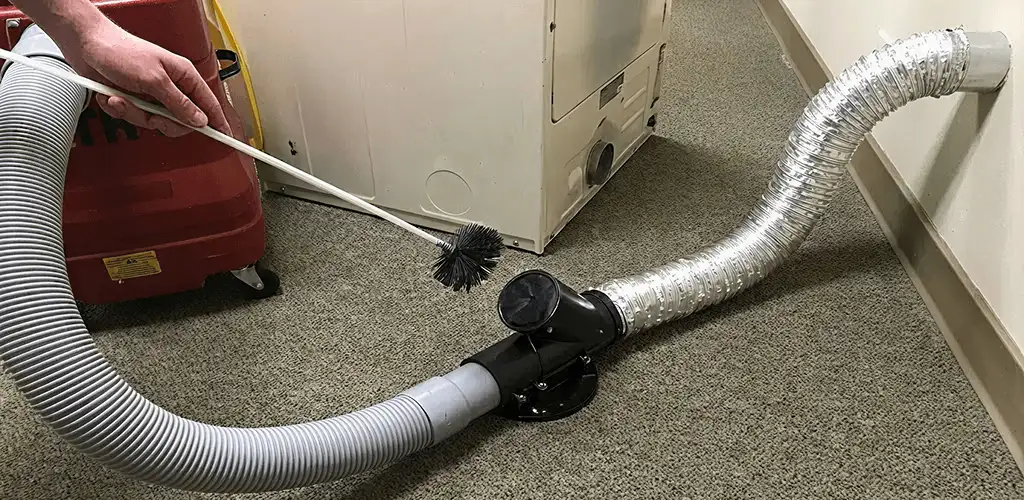 Dryer vent cleaning service removing lint from a dryer duct connection in Lincoln, NE