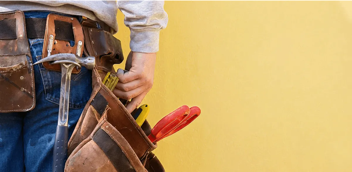 Handyman with tool belt ready for home repairs and maintenance in Lincoln, NE