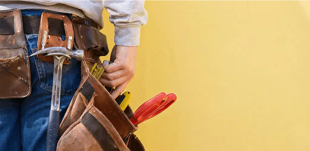 Handyman with tool belt ready for home repairs and maintenance in Lincoln, NE