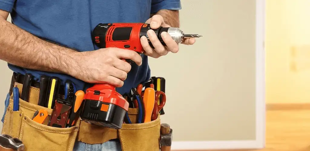 Handyman holding a power drill for home repairs and installations in Lincoln, NE