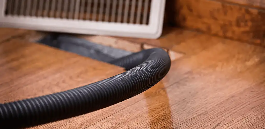Air duct cleaning hose inserted into a floor vent for ductwork cleaning in Lincoln, NE