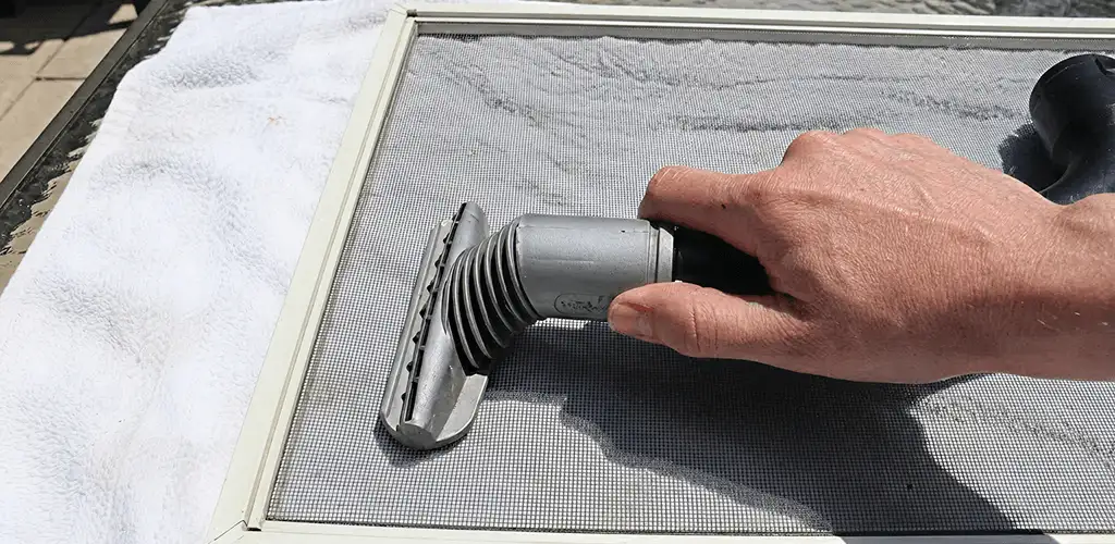 Window screen repair cleaning and fixing a damaged screen mesh in Lincoln, NE