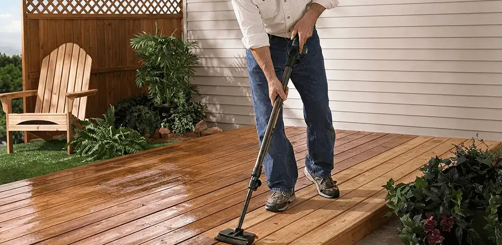 Deck staining service applying stain to a backyard wood deck in Lincoln, NE